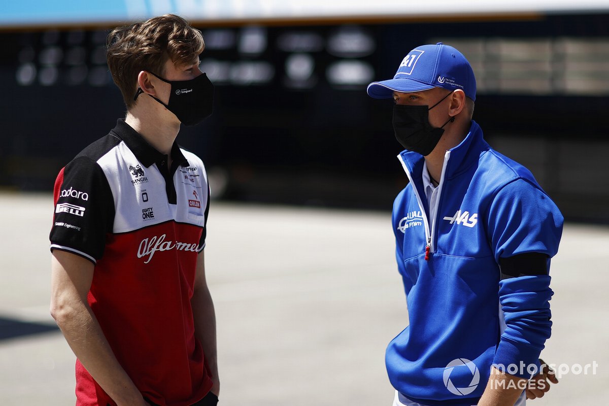 Callum Ilott, Test and Reserve Driver, Alfa Romeo Racing speaks to Mick Schumacher, Haas F1 in the paddock