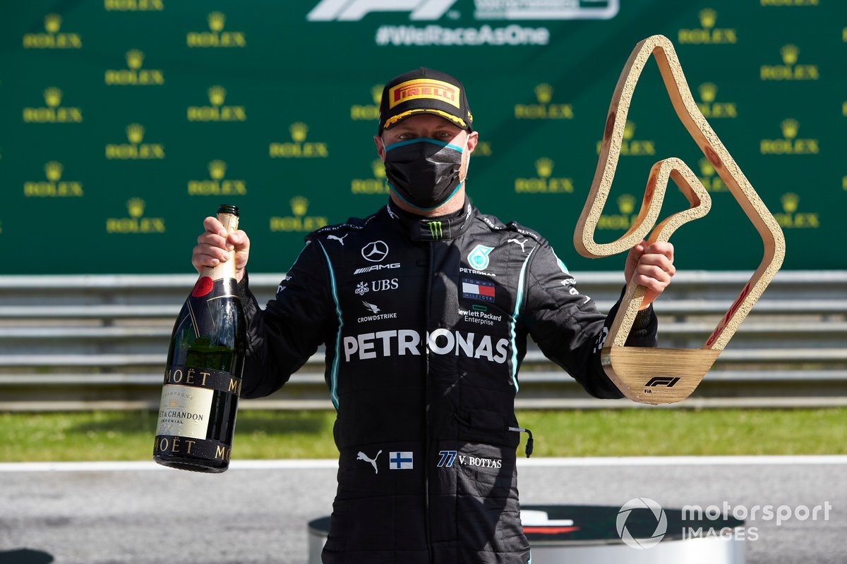 Valtteri Bottas, Mercedes AMG F1, celebrates with his trophy and champagne after the race