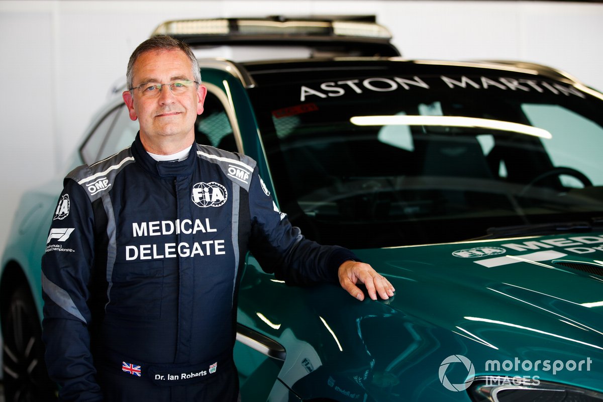 Dr Ian Roberts poses with the Aston Martin DBX medical car