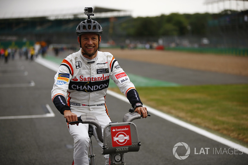 Jenson Button, McLaren, rides a bicycle