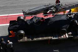The McLaren MCL32 of Stoffel Vandoorne is returned to the pit lane on the back of a truck