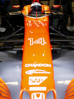 Fernando Alonso, McLaren, in cockpit, in garage, with helmet visor raised