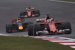 Sebastian Vettel, Ferrari SF70H, leads Daniel Ricciardo, Red Bull Racing RB13, and Kimi Raikkonen, Ferrari SF70H