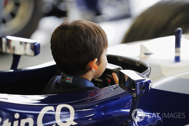 A young fan gets behind the wheel