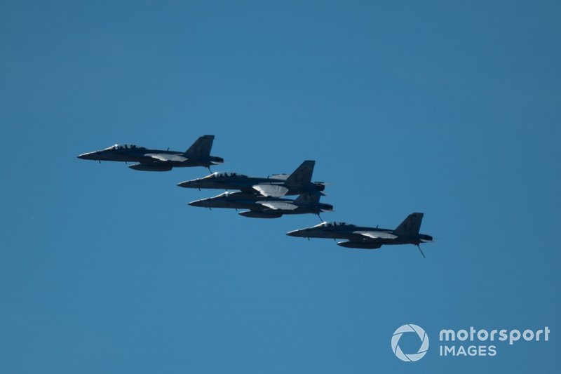 A quartet of US Navy F/A-18E Super Hornet fighter jets fly over the grid