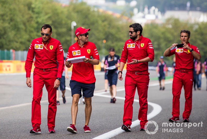 Sebastian Vettel, Ferrari, walks the track with colleagues