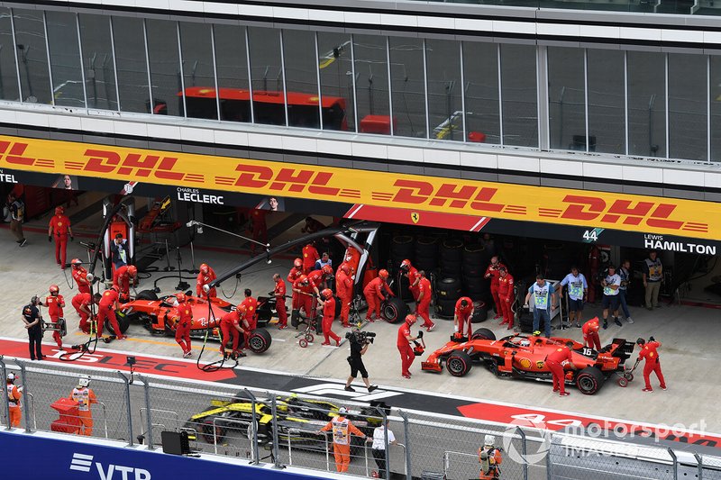 Sebastian Vettel, Ferrari SF90, and Charles Leclerc, Ferrari SF90, in the pits during practice