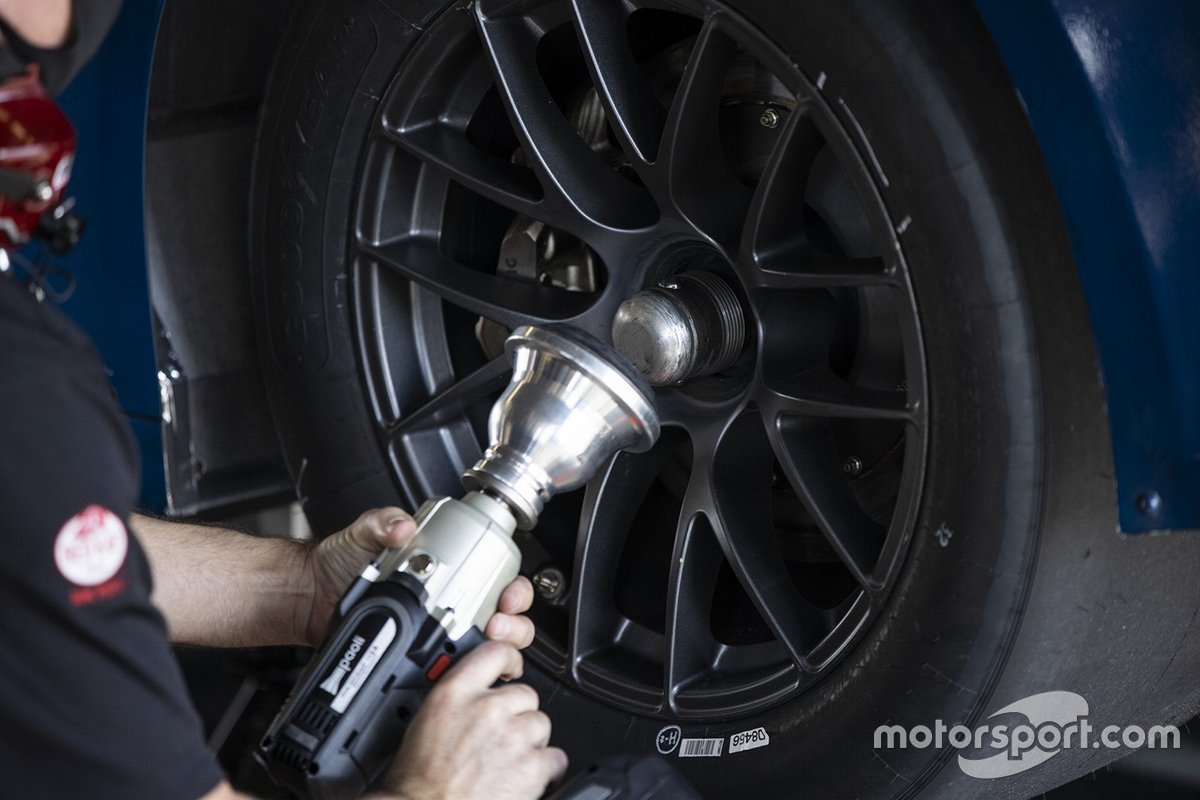 A team member makes adjustments to the NASCAR Next gen car