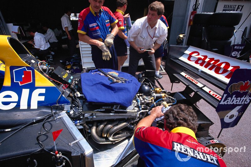 Mechanics work on a Williams FW14B Renault in the pits