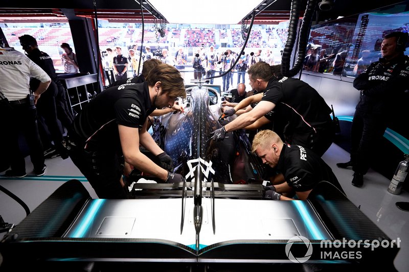 Mechanics at work on the car of Lewis Hamilton, Mercedes AMG F1 W10, in the garage