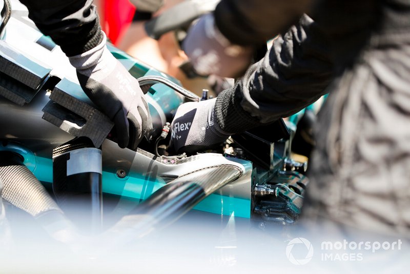Mercedes mechanics work on the car of Lewis Hamilton, Mercedes AMG F1 W10 on the grid