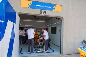 Fernando Alonso, McLaren Racing Chevrolet, crew prepare spare car after accident