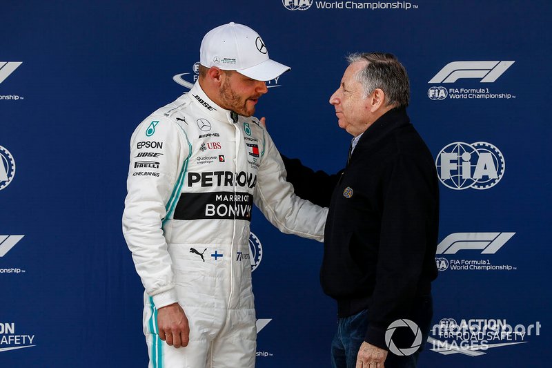 Valtteri Bottas, Mercedes AMG F1, is congratulated on securing pole position by Jean Todt, President, FIA