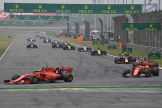 Charles Leclerc, Ferrari SF90, leads Sebastian Vettel, Ferrari SF90, Max Verstappen, Red Bull Racing RB15, Pierre Gasly, Red Bull Racing RB15, Daniel Ricciardo, Renault F1 Team R.S.19, Sergio Perez, Racing Point RP19, and the remainder of the field on the opening lap
