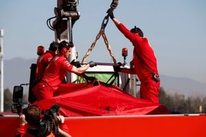 The car of Sebastian Vettel, Ferrari SF90 is recovered to the garage shielded by screens