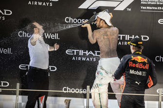 Bradley Lord, Head of Mercedes-Benz Motorsport Communications, Lewis Hamilton, Mercedes AMG F1 and Max Verstappen, Red Bull Racing celebrate on the podium with the champagne