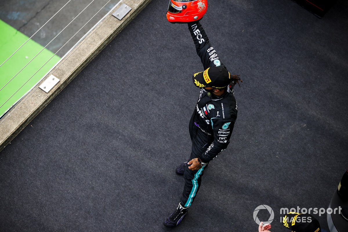 Lewis Hamilton, Mercedes-AMG F1, 1st position, arrives on the podium with the helmet of Michael Schumacher