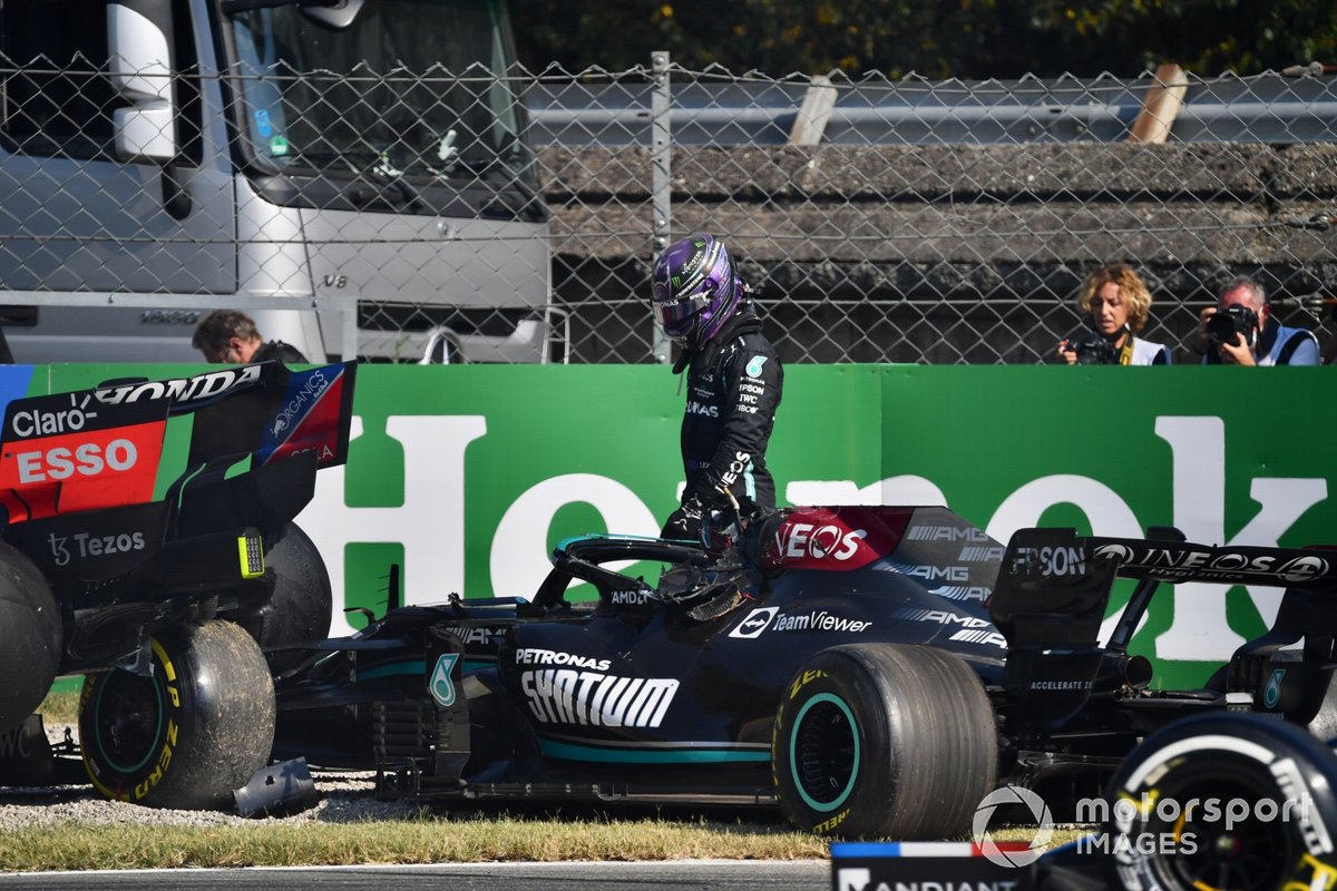Lewis Hamilton, Mercedes W12, climbs out of his car after crashing with Max Verstappen, Red Bull Racing RB16B