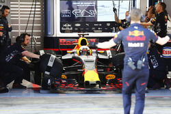 A Red Bull employee signals to Daniel Ricciardo, Red Bull Racing, as he prepares to exit his garage