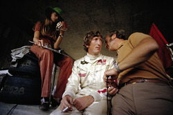 Jochen Rindt in pits with his time-keeping wife Nina and Lotus team boss Colin Chapman
