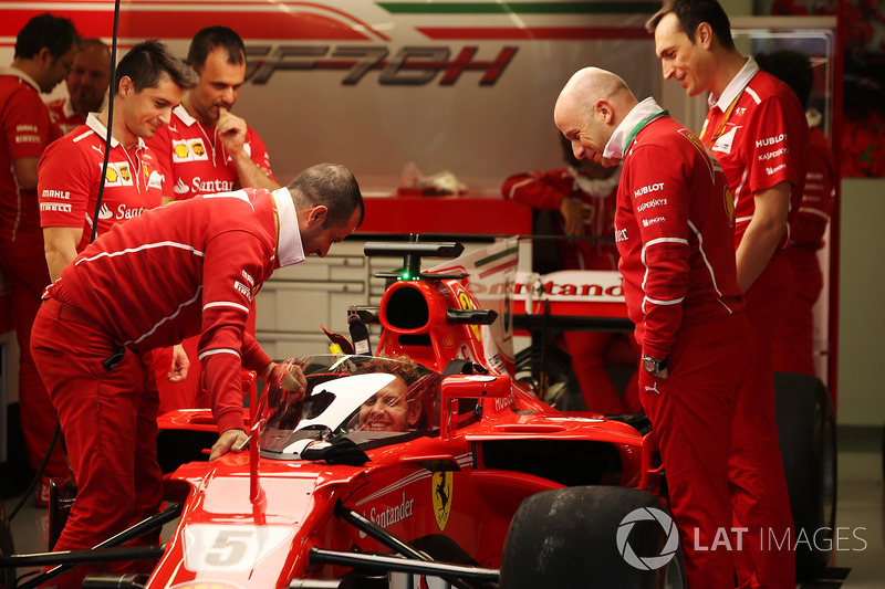 Sebastian Vettel, Ferrari, sits in the cockpit of his car, which is fitted with a new protective windscreen shield