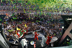 A burst of ticker tape covers the podium. Race winner Sebastian Vettel, Ferrari, 1st Position, celebrates with Luigi Fraboni, Head of Power Unit Race Operation, Ferrari. The pair are joined by Lewis Hamilton, Mercedes AMG, 2nd Position, and Valtteri Bottas, Mercedes AMG, 3rd Position