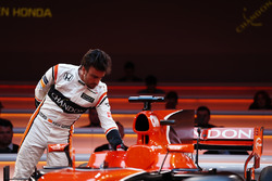 Fernando Alonso, McLaren, inspects the cockpit of the MCL32