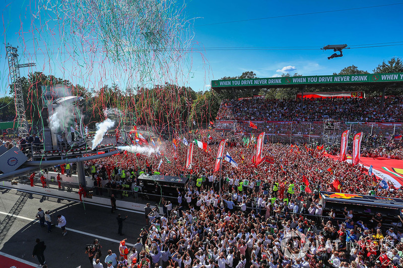 Sebastian Vettel, Ferrari, Lewis Hamilton, Mercedes AMG F1 and Valtteri Bottas, Mercedes AMG F1 celebrate on the podium and Ferrari Fans and flags at the podium celebrations