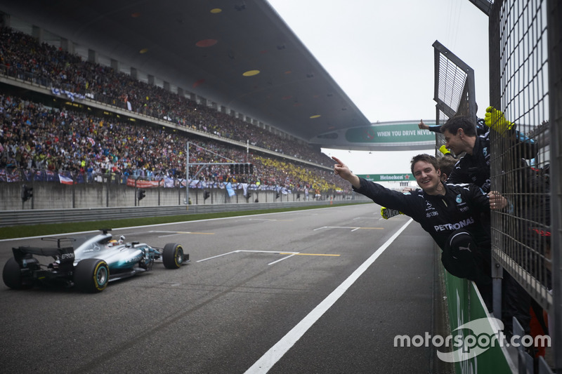 Lewis Hamilton, Mercedes AMG F1 W08, takes the chequered flag