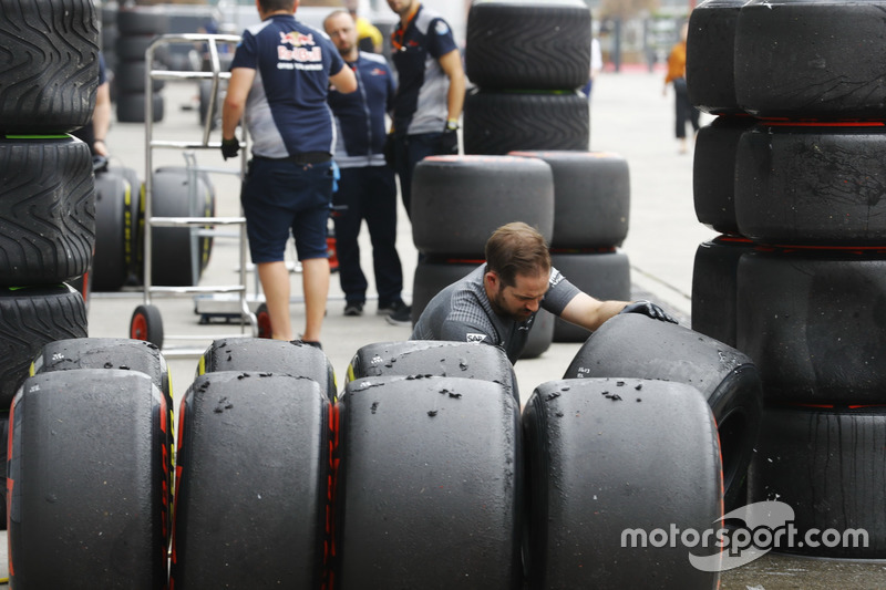 A McLaren engineer inspects sets of Soft and Super Soft tyres