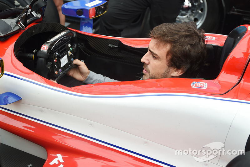 Fernando Alonso sits in the car of Marco Andretti