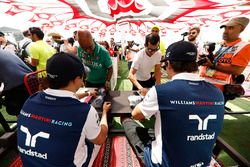 Felipe Massa, Williams, and Lance Stroll, Williams, sign autographs for fans