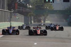 Fernando Alonso, McLaren MCL32, battles Daniil Kvyat, Scuderia Toro Rosso STR12, as behind Stoffel V