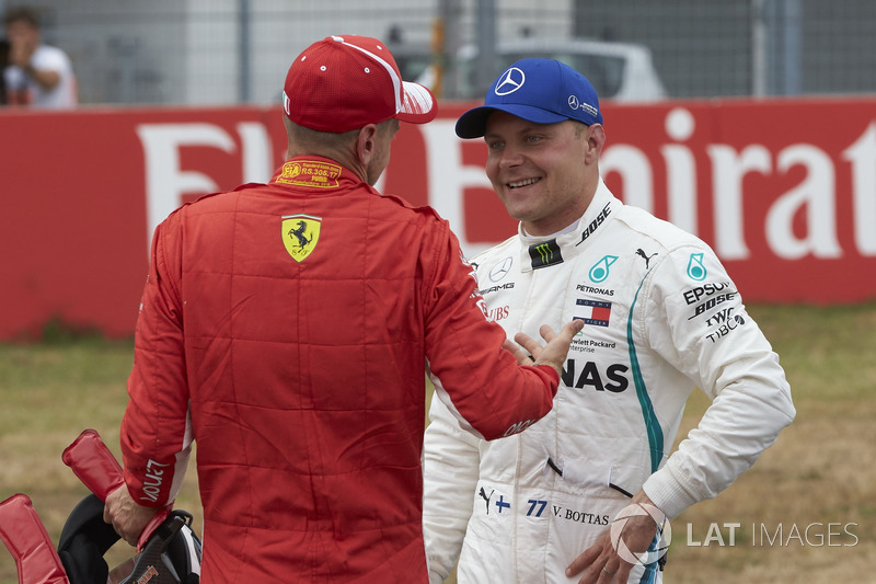 Pole sitter Sebastian Vettel, Ferrari, and Valtteri Bottas, Mercedes AMG F1