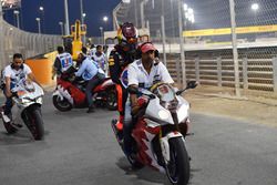 Max Verstappen, Red Bull Racing is given a lift on a motorbike