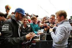 Lewis Hamilton, Mercedes AMG F1 and team mate Nico Rosberg, Mercedes AMG F1 sign autographs for the fans