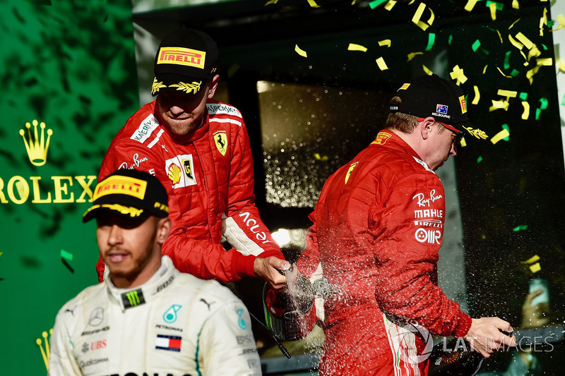 Sebastian Vettel, Ferrari and Kimi Raikkonen, Ferrari celebrate on the podium with the champagne