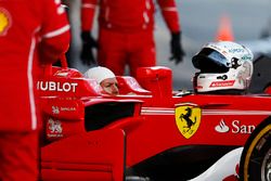 Sebastian Vettel, Ferrari, in cocpkpit wearing balaclava, but with helmet removed