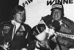 Third place James Hunt, McLaren, world champion Mario Andretti, Lotus