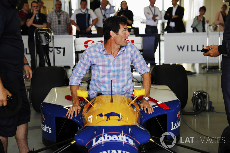 Mark Webber enters the cockpit of an FW14 Renault Sport F1 Team