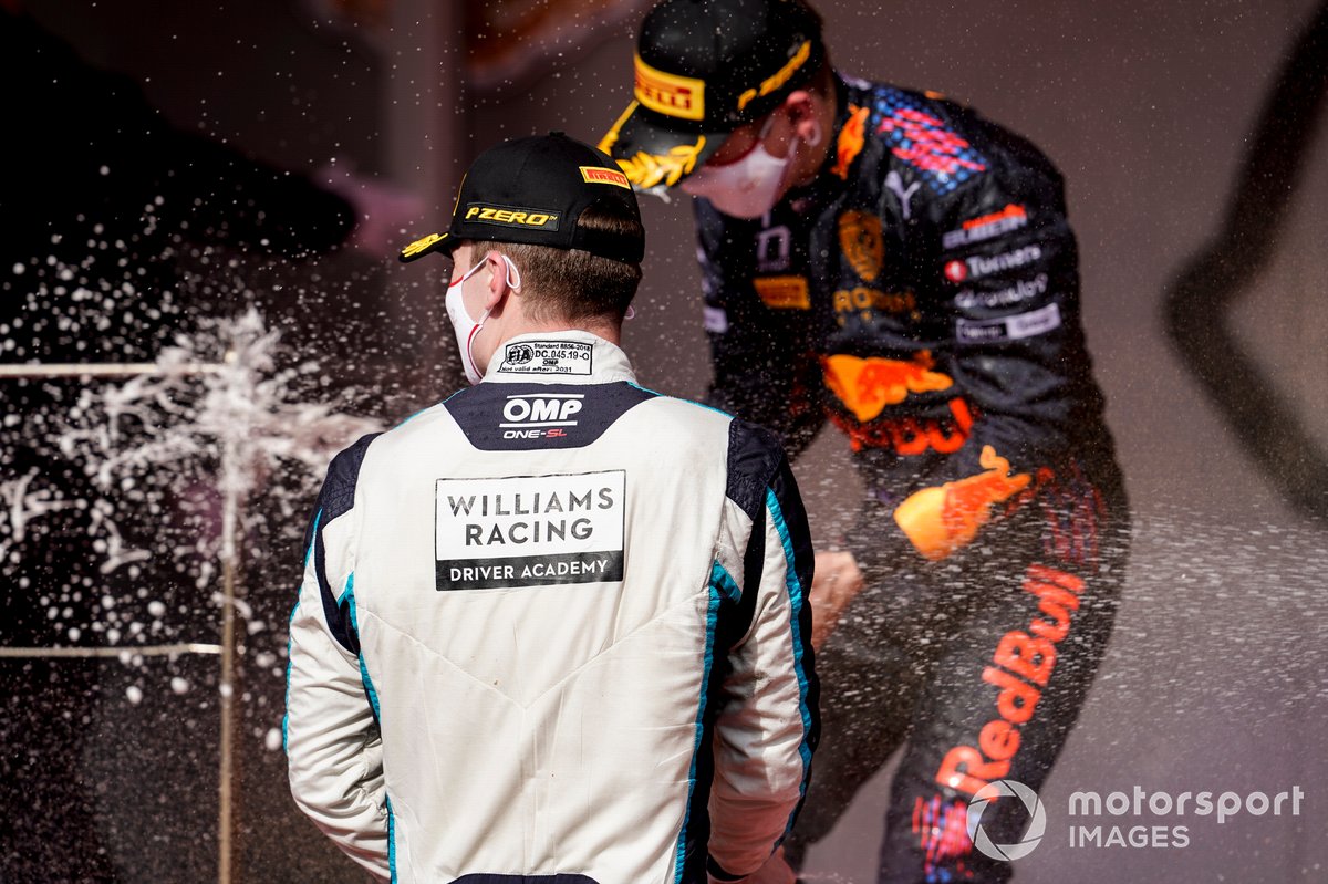 Dan Ticktum, Carlin, 2nd position, and Liam Lawson, Hitech Grand Prix, 1st position, spray champagne on the podium