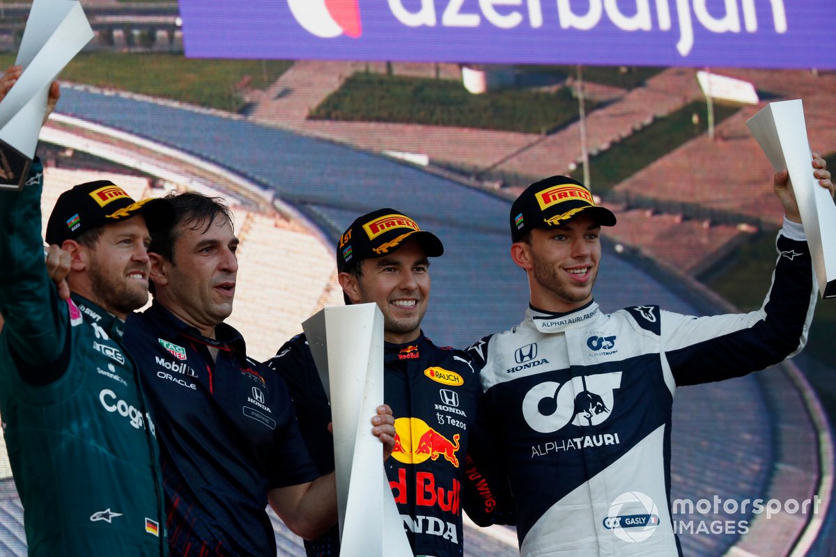 Sebastian Vettel, Aston Martin, 2nd position, the Red Bull trophy delegate, Sergio Perez, Red Bull Racing, 1st position, and Pierre Gasly, AlphaTauri, 3rd position, on the podium