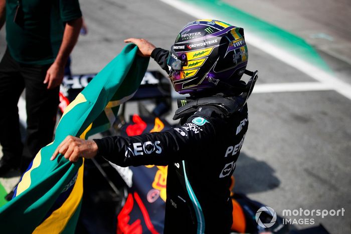 Ganador Lewis Hamilton, Mercedes, celebra Parc Ferme con una bandera brasileña