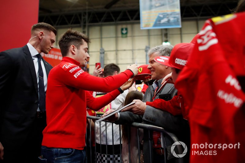 Charles Leclerc, Ferrari signs autographs for fans in front of the Autosport stage