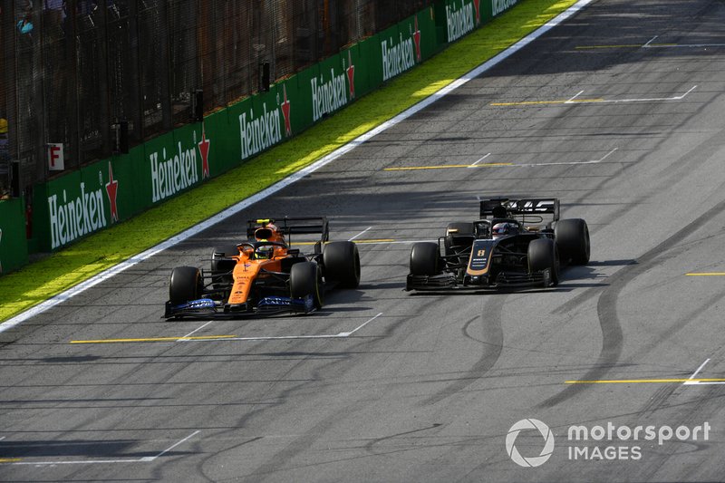 Lando Norris, McLaren MCL34, passes Romain Grosjean, Haas F1 Team VF-19