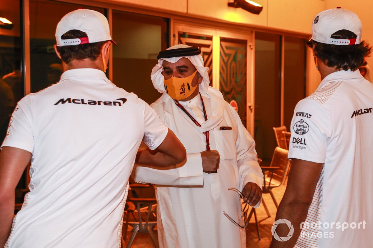 Lando Norris, McLaren, bumps elbows with Crown Prince Salman bin Hamad bin Isa Al Khalifa as Carlos Sainz Jr., McLaren, looks on