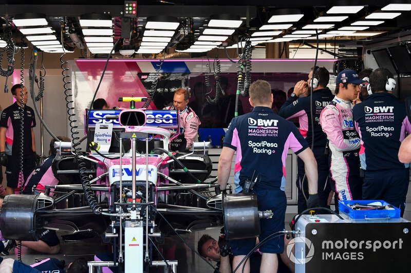 Lance Stroll, Racing Point, and Racing Point mechanics in the garage