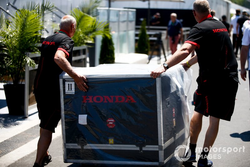 Meccanici Honda spostano una cassa del motore