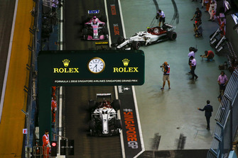 Marcus Ericsson, Sauber C37, Nico Hulkenberg, Renault Sport F1 Team R.S. 18, Charles Leclerc, Sauber C37, and Esteban Ocon, Racing Point Force India VJM11, in the pit lane.
