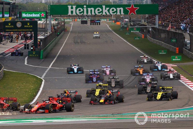 Charles Leclerc, Ferrari SF90, leads Sebastian Vettel, Ferrari SF90, Max Verstappen, Red Bull Racing RB15, Pierre Gasly, Red Bull Racing RB15, Nico Hulkenberg, Renault F1 Team R.S. 19, Daniel Ricciardo, Renault F1 Team R.S.19, Romain Grosjean, Haas F1 Team VF-19, and the remainder of the field at the start of the race